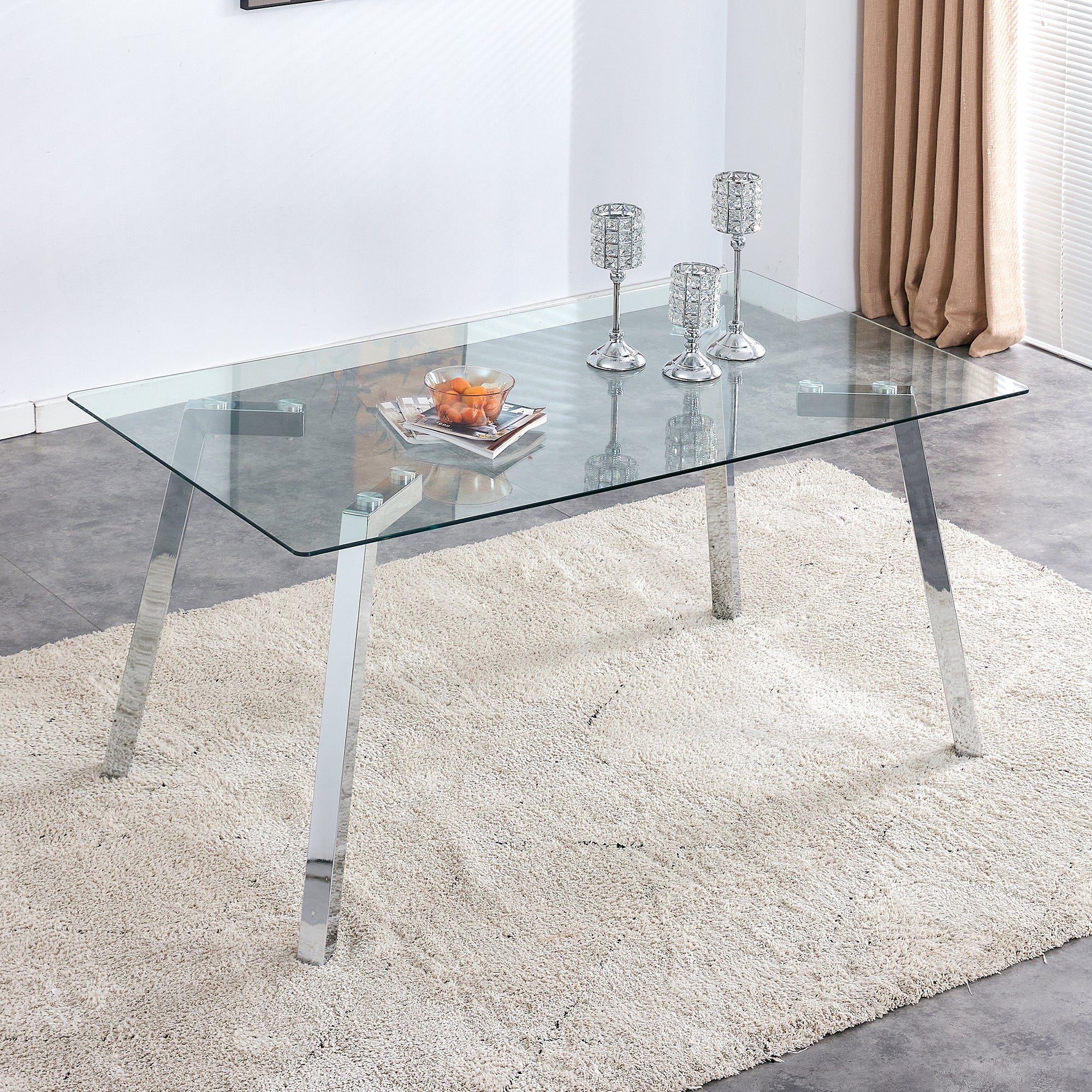 A modern minimalist rectangular glass dining table with tempered glass tabletop and silver metal legs, suitable for kitchens, restaurants, and living rooms,63'*35.4'*30'